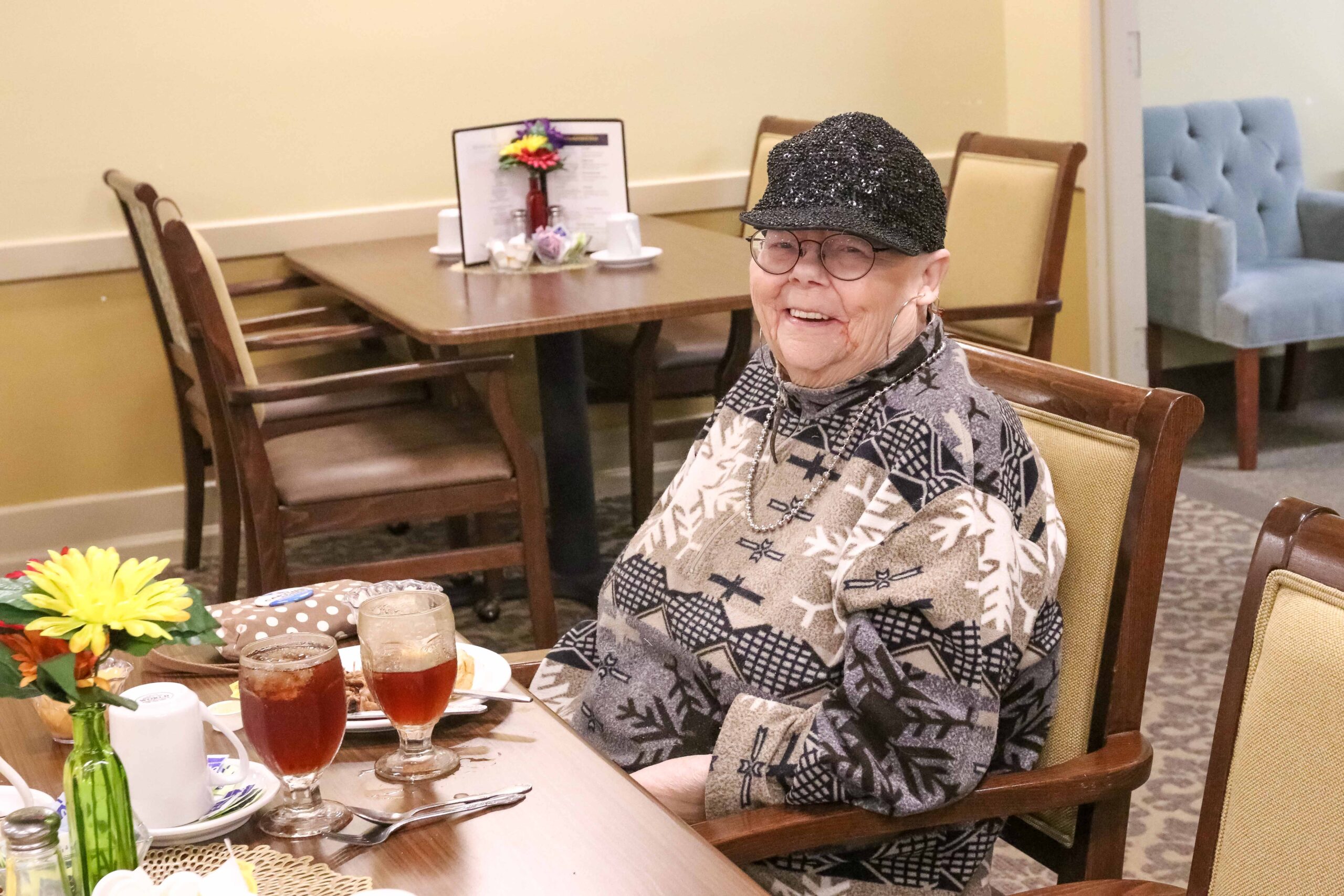 Smiling resident enjoying a meal at Sedgwick Plaza, a quality senior living community.